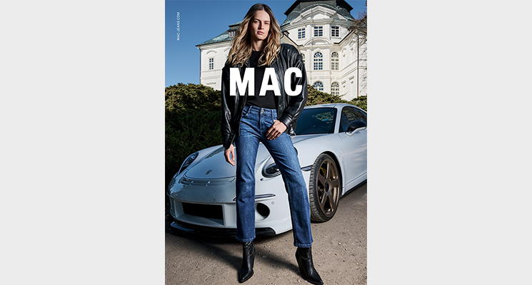 Frau vor Porsche mit Lederjacke und Jeans von Mac