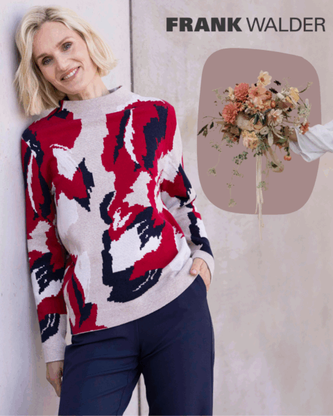 Frank Walder Model mit Rot/weiß/schwarzem Pullover. Beworben wird die Blumenstrauß Aktion.