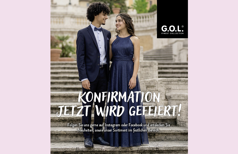 Junges Paar im Anzug und festlichem Kleid der Marke GOL stehend auf einer Treppe