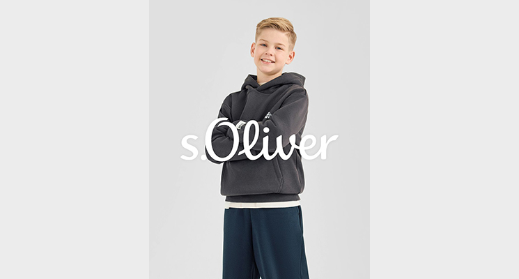 Junge in schwarzem Kapuzenpullover und blauer Hose von S Oliver